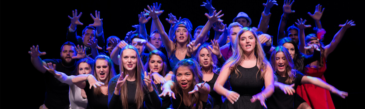 Group photo of fraternity and sorority members performing a lip sync routine